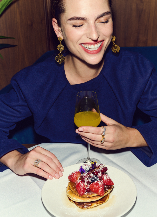 Woman in blue dress with a glass in her hand